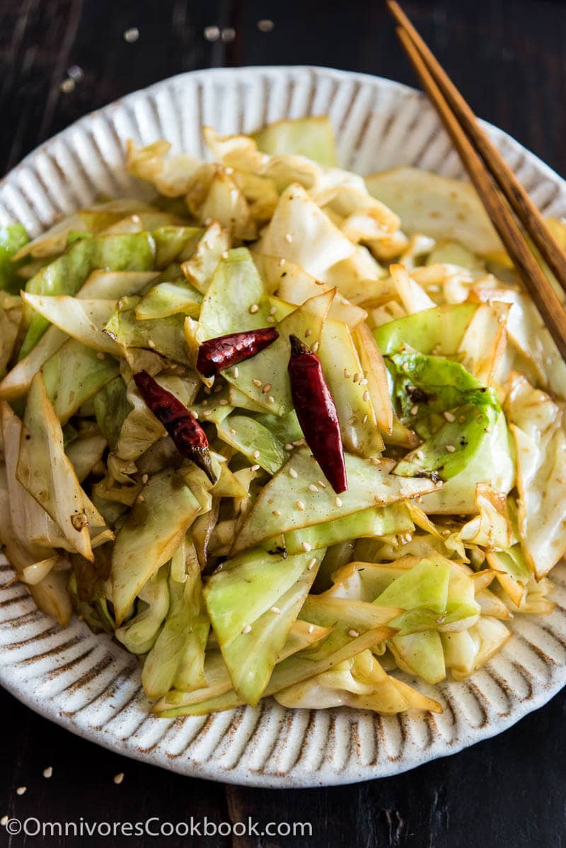 Infuse the oil with aromatics and then toss at a high heat, this adds a smoky flavor to the sweet fried cabbage and makes a quick and delicious side dish.