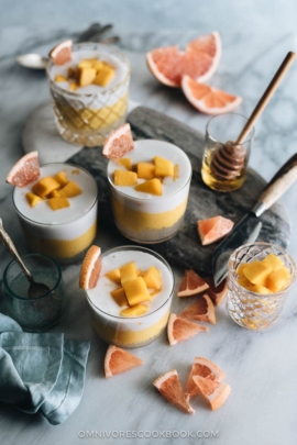 Four cups of mango sago served with grapefruits as a garnish