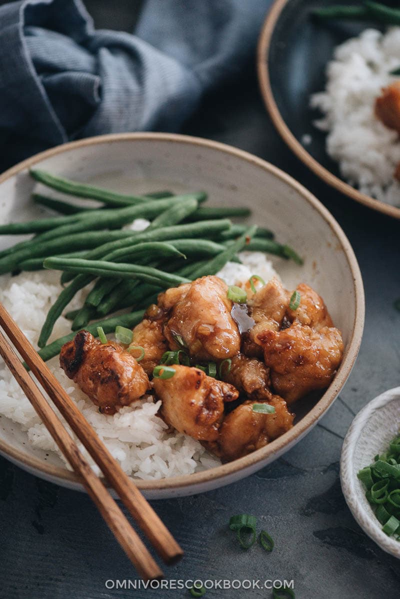 Homemade crispy Chinese honey chicken served in bowls close up