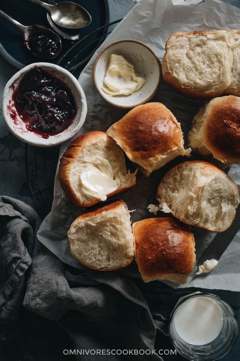 Pulled-apart dinner rolls with butter and jam