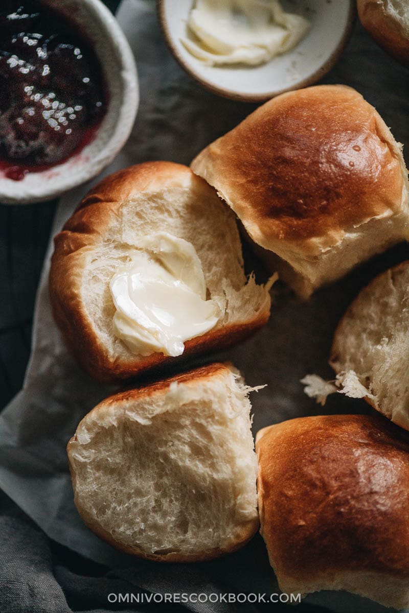 Pulled-apart dinner rolls with butter close-up