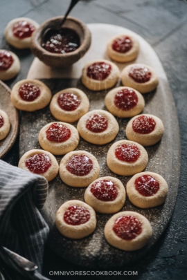 Strawberry thumbprint cookies dust with powdered sugar