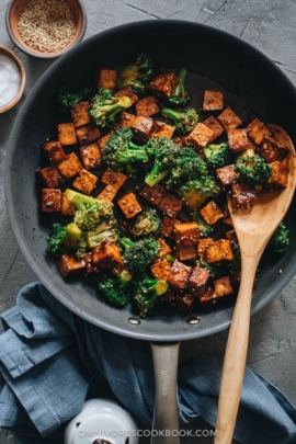 Tofu with broccoli in brown sauce in frying pan