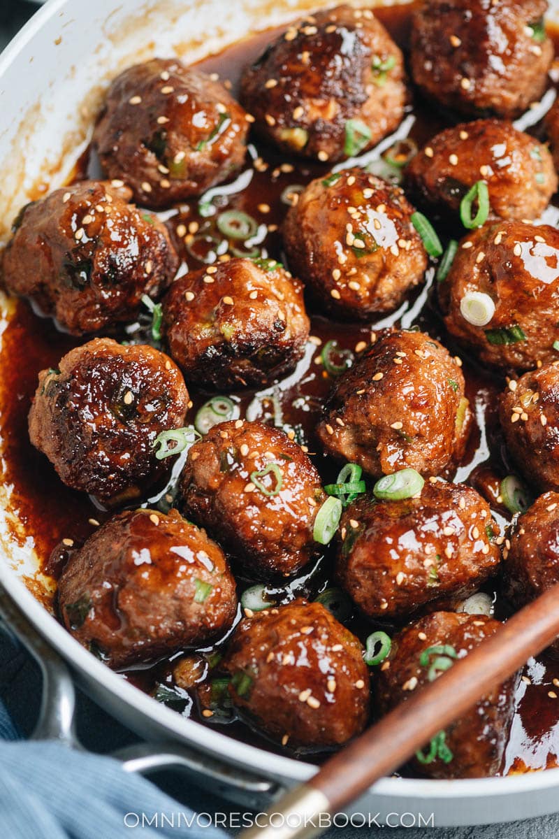 Close-up of brown meatballs in a white skillet