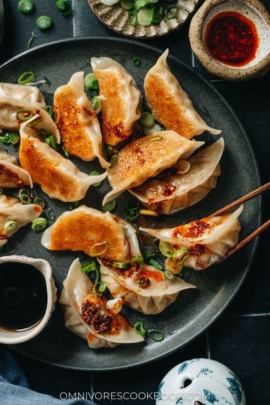 Pan fried dumplings with chili oil and scallion