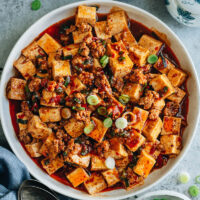 An easy mapo tofu recipe that creates the authentic taste of China and features soft tofu cooked in a rich, spicy, and savory sauce that is full of aroma. Serve it over steamed rice for a quick, delicious and healthy weekday dinner!