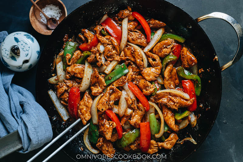 Chinese restaurant style black pepper chicken in a wok close up