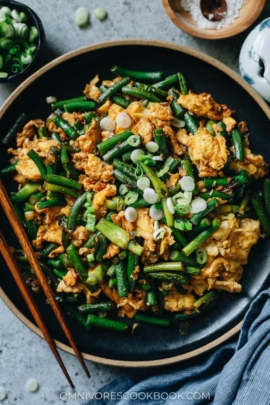 Stir fried garlic scape with scrambled eggs close up