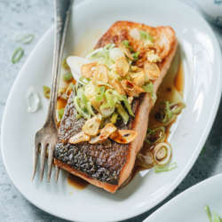 Crispy salmon features perfectly cooked salmon with crispy skin, finished up with a fragrant garlic and ginger sauce. It is an easy main dish that you can put together quickly for a weekday dinner. {Gluten-Free adaptable}